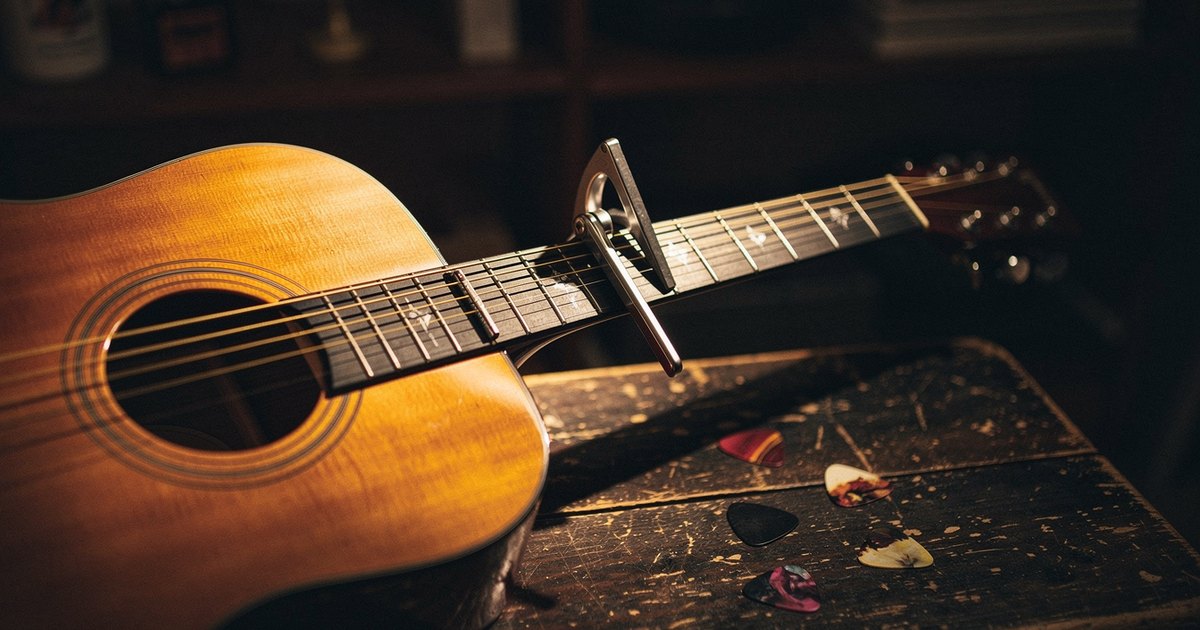 An acoustic guitar with a capo clamped on its neck, the physical version of transposing a song to a new key, which is the core idea behind the Nashville Number System.
